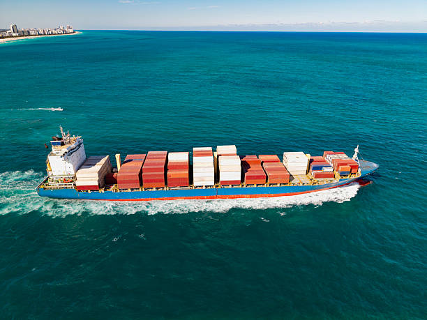 istock Freight container loaded on cargo vessel. Aerial view cargo ship leaving harbor. Cargo business. Container ship. Shipping logistics. Commercial shipping. Cargo ship in sea, aerial view 2228724187