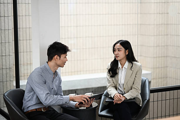 istock Male and female colleagues having a conversation in a modern office 2228727442