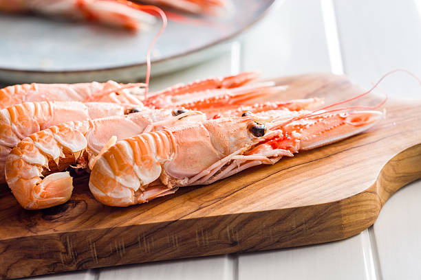 istock Scampi langoustine on cutting board on white table. 2228728271