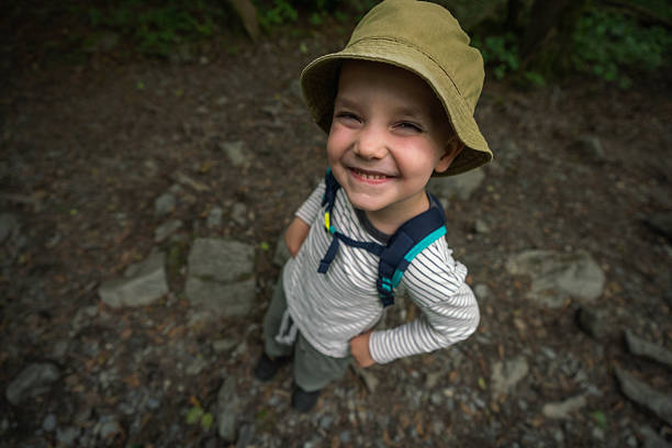 istock Happy Smiling Child Hiking Outdoors Wearing a Hat and Backpack 2228729358