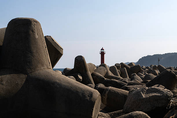 istock tetrapods with lighthouse at the harbor 2228733788