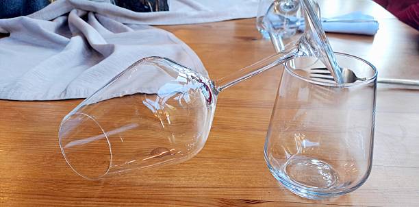 istock Decorated  wooden table with tablecloth, wine and water glass, empty, close up 2228736457