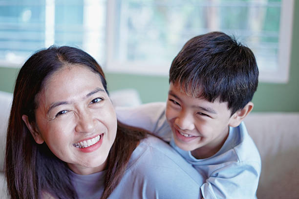 istock A happy smile between mother and son on the sofa. 2228736600