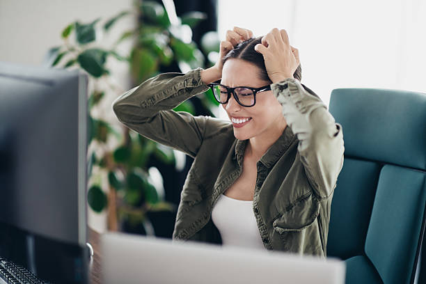 istock Young woman frustrated while working remotely on her computer at home office, dealing with technology challenges 2228741527