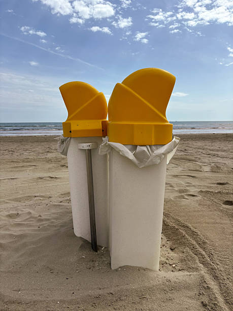 istock Plastic waste containers with yellow lids are installed on the beach. 2228744194
