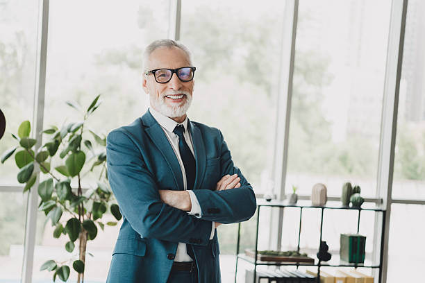 istock Successful senior businessman in formal suit smiling confidently in modern office workspace with greenery 2228744572