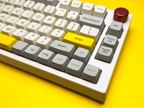 istock White mechanical keyboard with bright Enter key on bright yellow background, minimalism, keyboard buttons. A keyboard with a yellow key on the bottom left 2228744671