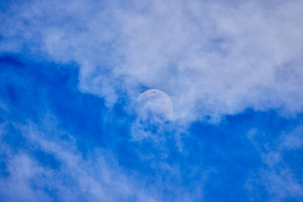 Beautiful landscape with the moon among the clouds