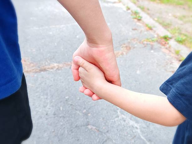 istock help friend through a tough time. Holding hands together. holding hands 2228747491
