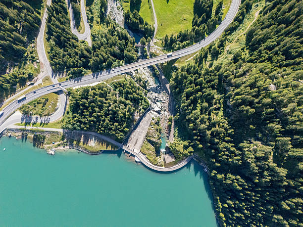 istock Curved Dam and Turquoise Reservoir with Road 2228749017