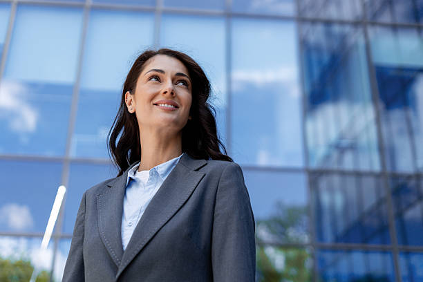 istock Confident Businesswoman Standing by Modern Office Building 2228749899