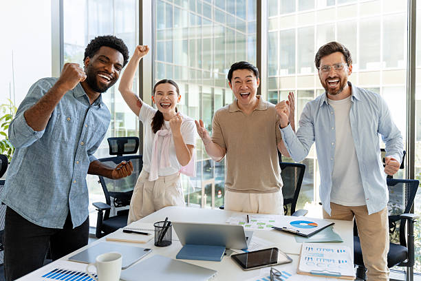 istock Excited business team celebrating success in modern office 2228750003