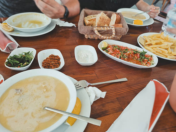 istock Shared meal with Turkish bread, sauces, soups and fries 2228750902