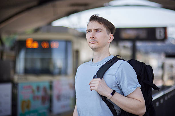 istock Foreign tourists standing at a tram station 2228750913