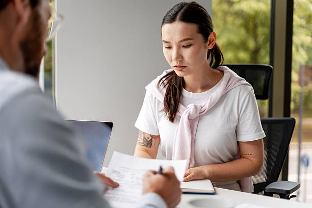 istock Young Professional Woman Reviewing Documents in Office 2228752324