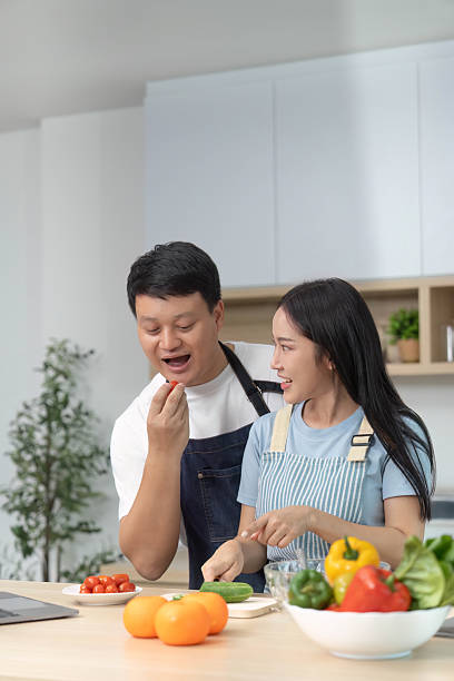 istock Couple Enjoying Healthy Cooking: Preparing Fresh Ingredients in Kitchen 2228752898