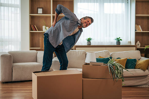 istock Mature man suffering back pain while carrying boxes at home 2228754320