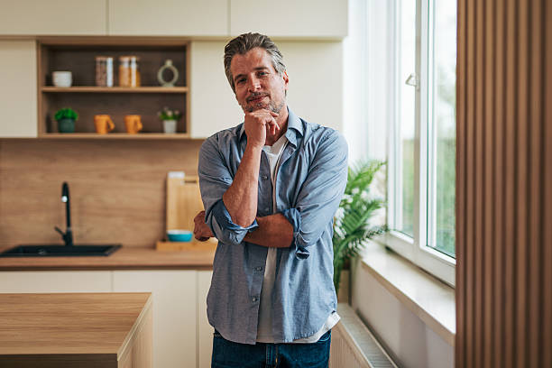 istock Thoughtful mature man contemplating in modern kitchen 2228754425