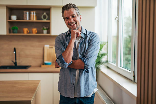 istock Smiling mature man posing in modern kitchen 2228754558