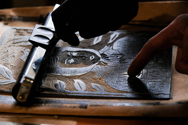 istock Inspecting Inked Linocut Block Before Printing 2228754603