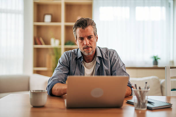 istock Focused middle-aged freelancer working from home on laptop 2228757146