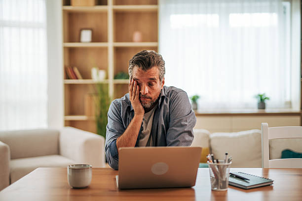 istock Tired businessman feeling bored while working from home 2228757259