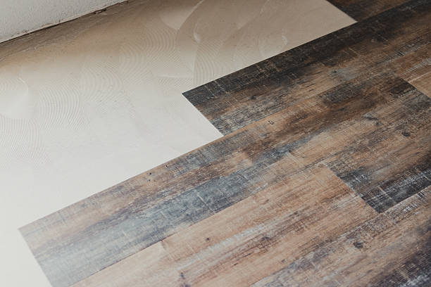 istock Installing vinyl wood planks over concrete subfloor during home renovation 2228758894