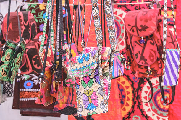 Kazakhstan, Almaty - June 28, 2025: Bright textile bags, handmade souvenirs with traditional Uzbek patterns on a market stall. Products of Central Asian craftsmen.