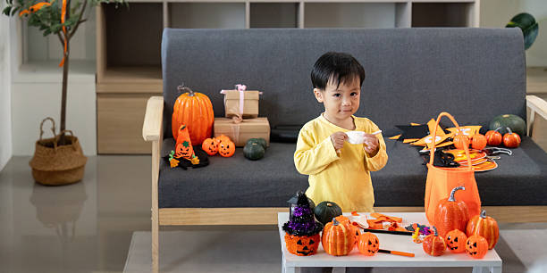 istock Creative Halloween Fun. A young boy enjoys crafting with festive decorations around him. 2228760203