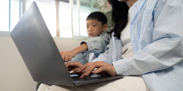 istock Learning Together. Mother and son collaborating on a laptop. 2228760782