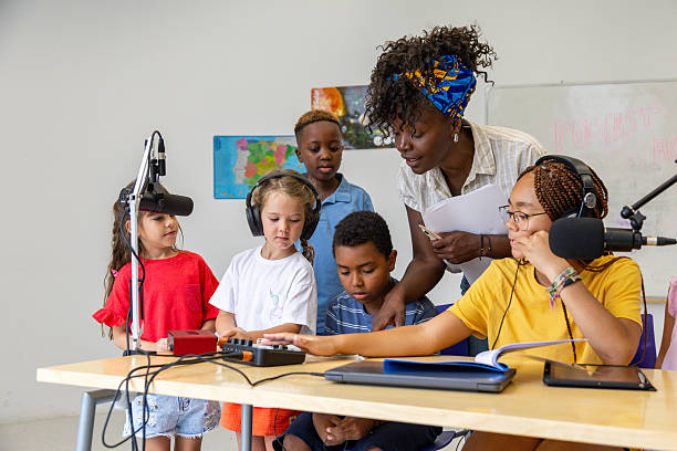 istock Elementary school students recording a podcast with their teacher 2228763147