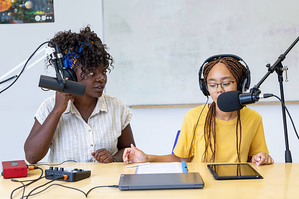 istock Two young female podcasters recording a show in a studio 2228763149