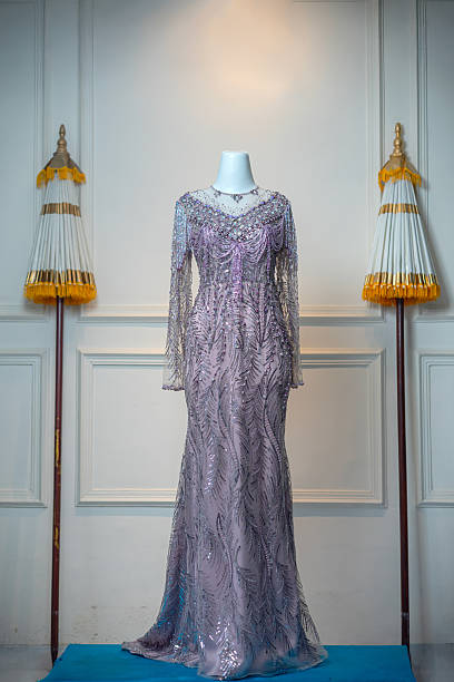 istock Elegant lilac evening gown with intricate beaded details and sequin patterns, displayed on a mannequin in a luxurious indoor setting with cultural accents. 2228763413