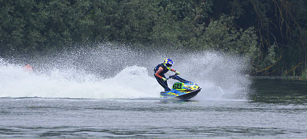 Wyboston, Bedfordshire, England - MAY 18, 2024:    Jet Ski racer cornering at speed creating at lot of spray
