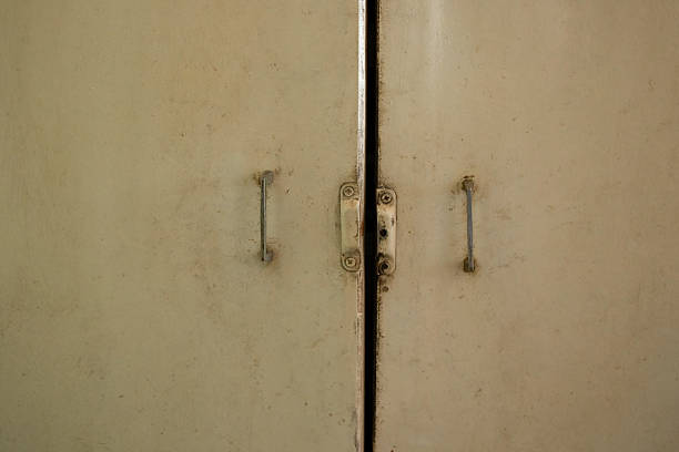 istock Old kitchen cabinet doors with white paint and iron handles in an apartment 2228766363