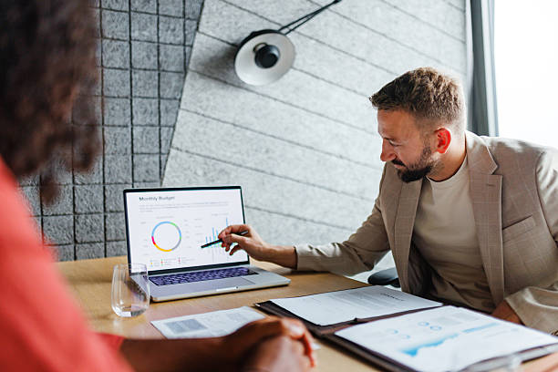 istock Business Advisor Meeting with Client Discussing Monthly Budget 2228766556