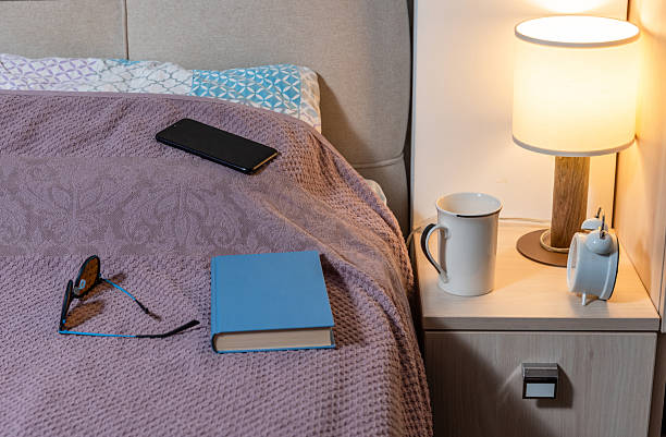 istock Bedside with a lamp and alarm clock 2228766964