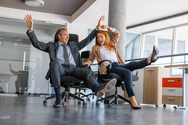 istock Business colleagues having fun riding on office chairs 2228767794