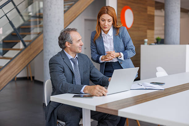 istock Business colleagues collaborating on laptop in modern office 2228768099