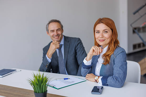 istock Business people smiling at the camera during a meeting 2228768230