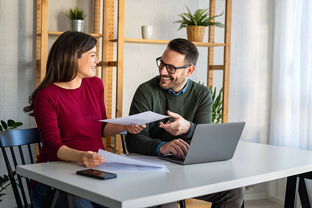 istock Happy businesspeople laughing while collaborating on a new project in an office. 2228768303