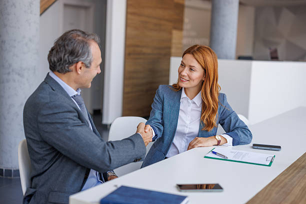 istock Businesspeople shaking hands after successful meeting in office 2228768334