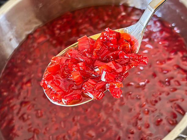 istock Spoon of Vibrant Red Relish over a Pot 2228768802