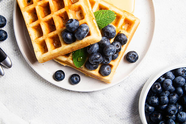istock Waffles with blueberries, ice cream, and honey on a plate 2228769136