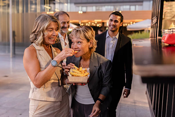 istock Colleagues enjoying street food during break 2228770157