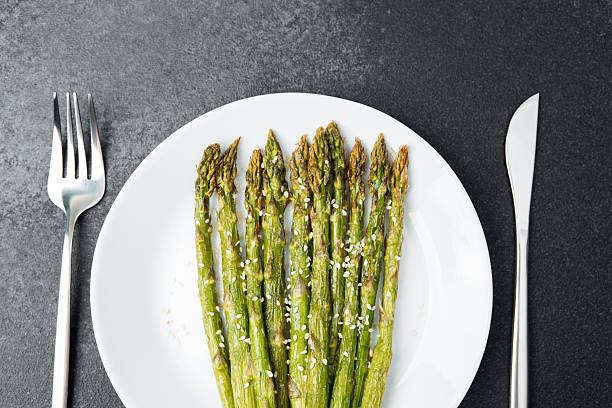 istock Freshly cooked asparagus served with sesame on a white plate 2228770380