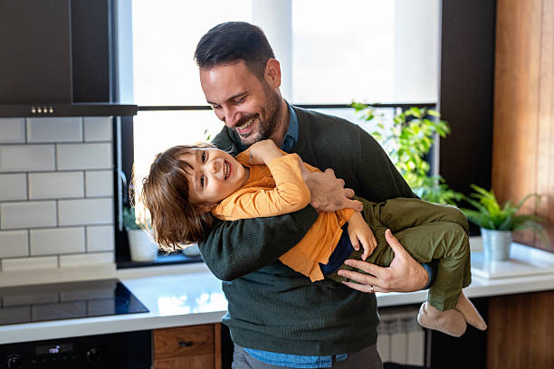istock Affectionate single dad enjoy chatting with little son tell about passed day, having fun together 2228771171