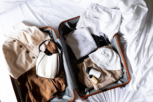 istock Open suitcase with clothing and accessories on a bed 2228771349