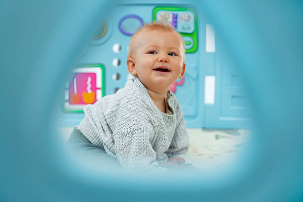 istock Happy Baby in Playpen Seen Through Hole 2228773012