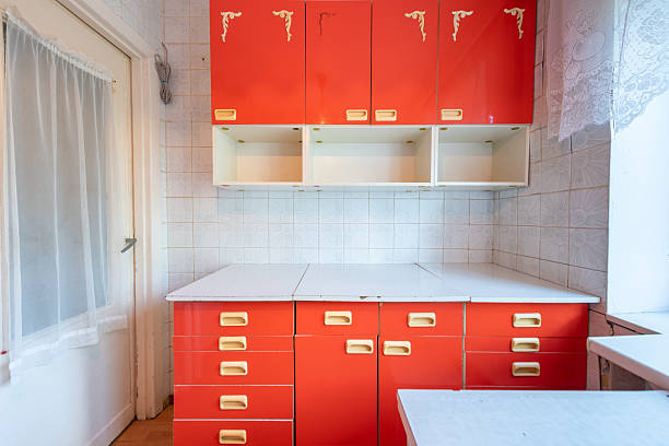 Brightly colored vintage red kitchen cabinets featured in a traditional retro kitchen atmosphere.